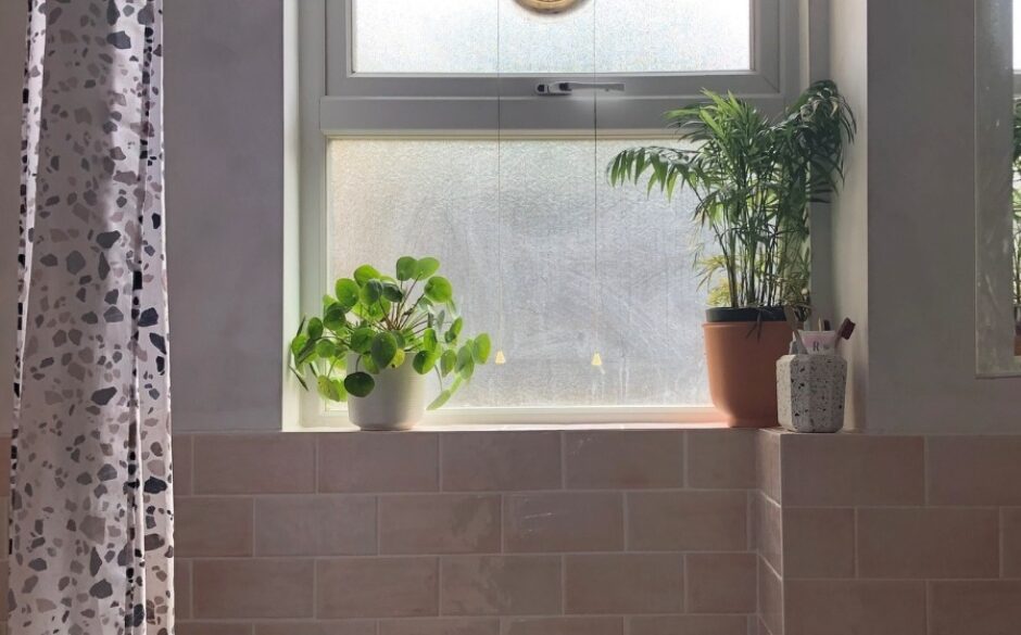 Gamma Pink Bathroom tiles with plants sat atop the windowsill to add a pop of green,