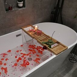 Contemporary Bathroom with Grey Cemento Wall and Floor Tiles and rose petals in the bath
