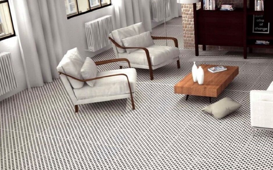 Living room setting with black and white Victorian tiles. There are two armchairs and a coffee table.