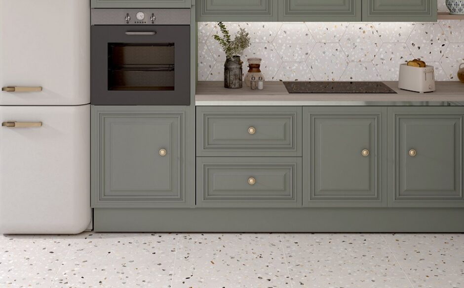 Kitchen with green units. Terrazzo tiles on the floor and walls.
