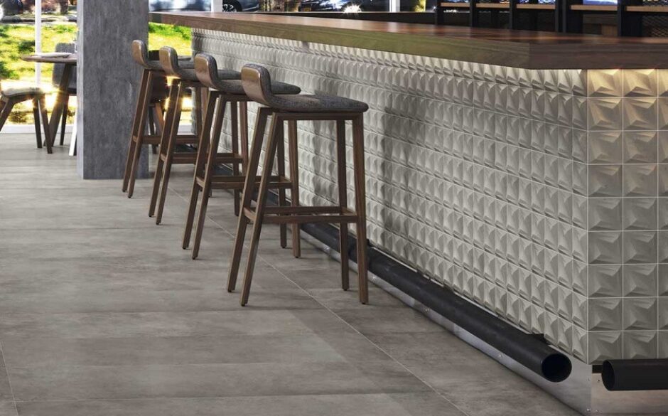 An outdoor bar with funky tiles and four bar stools.