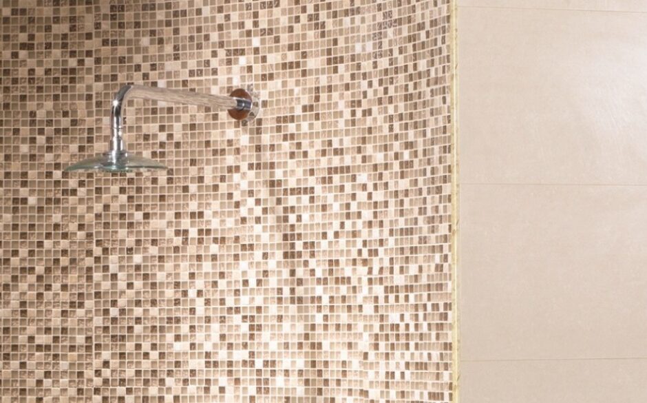 Beige sparkly mosaic tiles on a shower wall
