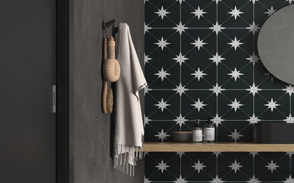 Black tiles with white starts on them in a bathroom setting
