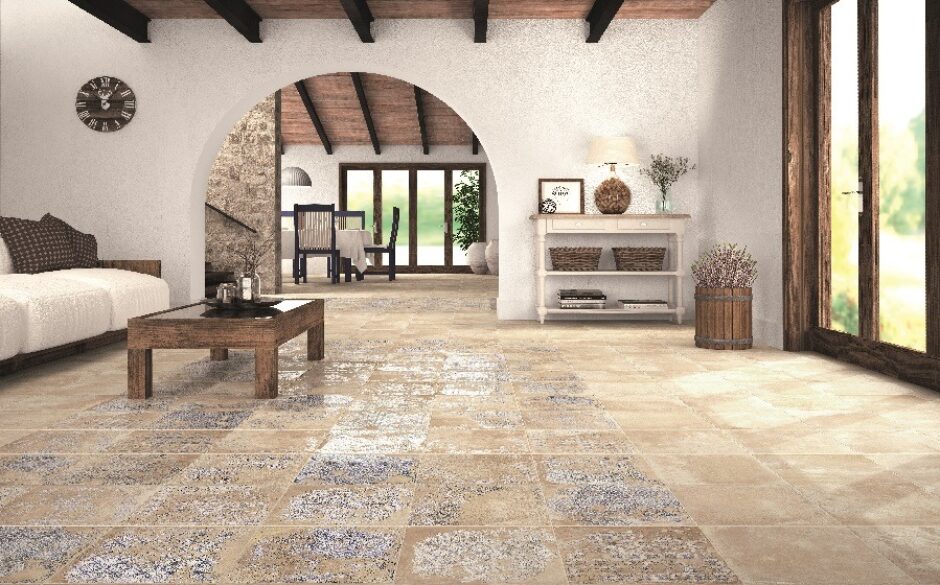 A rustic interior with an open plan feel. Arched doorway and beamed ceiling. Patterned Moroccan tiles on the floor.