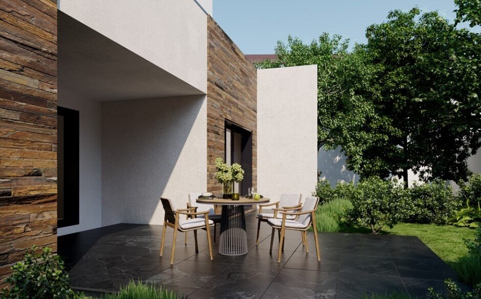 Black porcelain patio tiles in a beautiful outdoor setting. Patio table and chairs and a mixture of white and tiled exteriors.