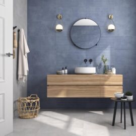 Eleganza Blue Ripple Tiles on a bathroom wall with a wooden unit and round mirror