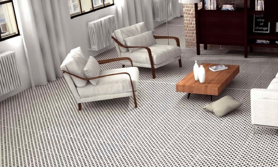 Living room setting with black and white Victorian tiles. There are two armchairs and a coffee table.