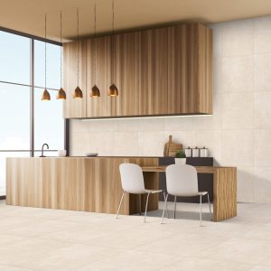 Jude Ivory Matt Tiles. View of a kitchen with beige walls, wooden furniture and white chairs. There is a large window.